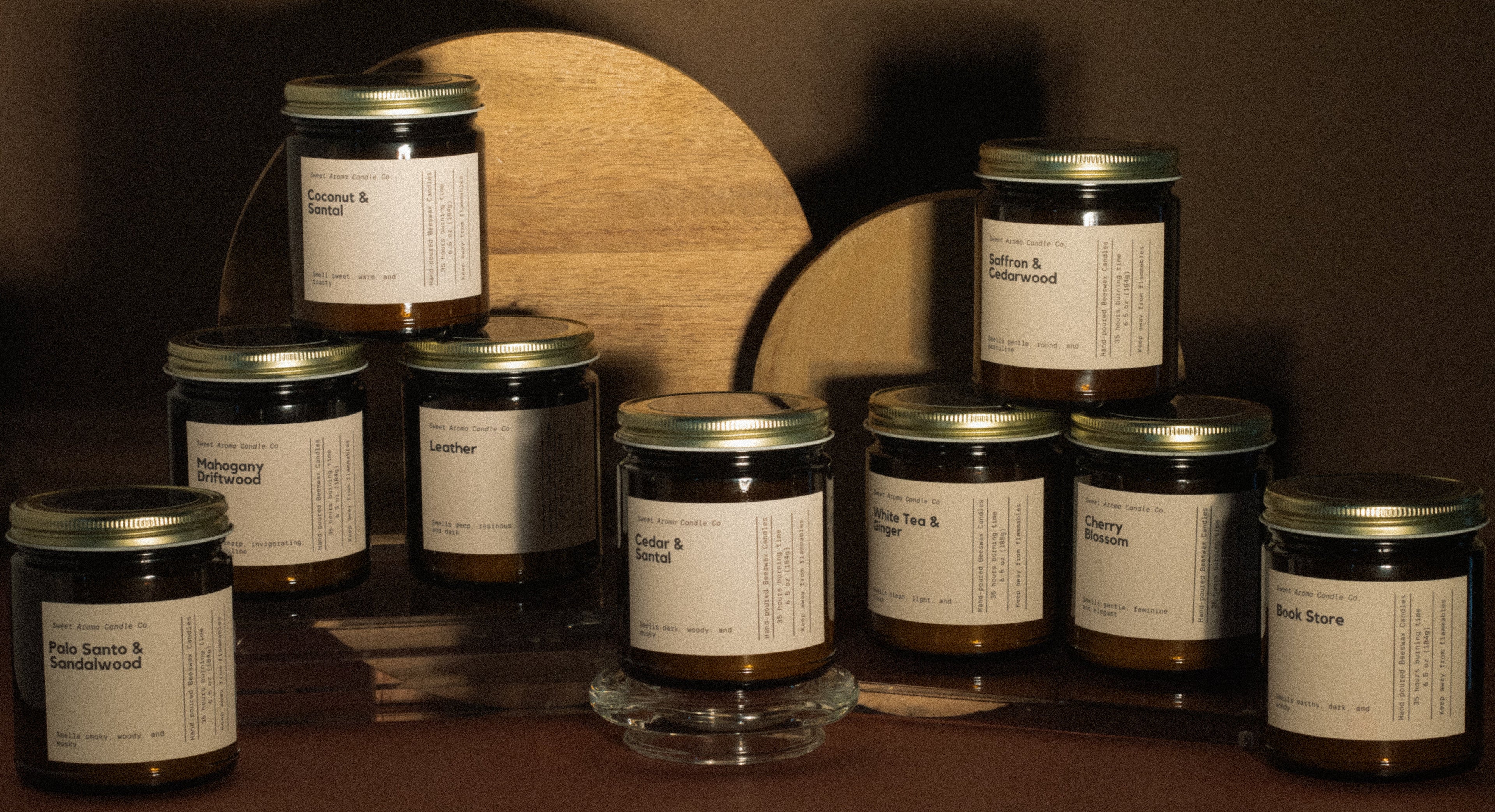 Candles in front of a wooden board against a dark background